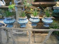 Set of four French enameled cast iron urns